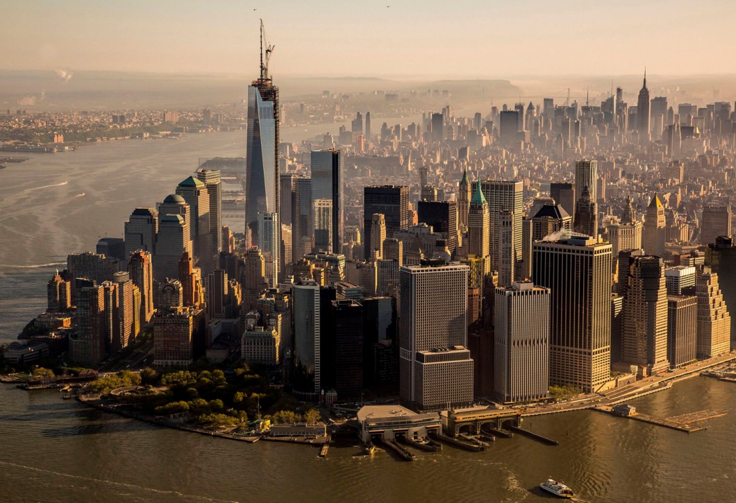 The final piece of the spire at One World Trade Center is lifted into place in New York